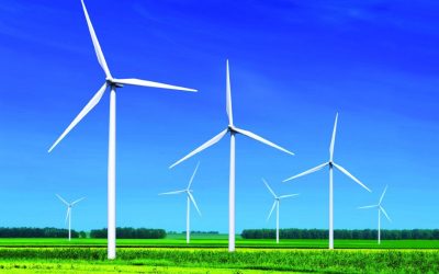 wind turbines on green grass under blue sky